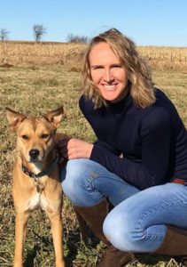 Vet Kitt Schaller next to one of her dogs